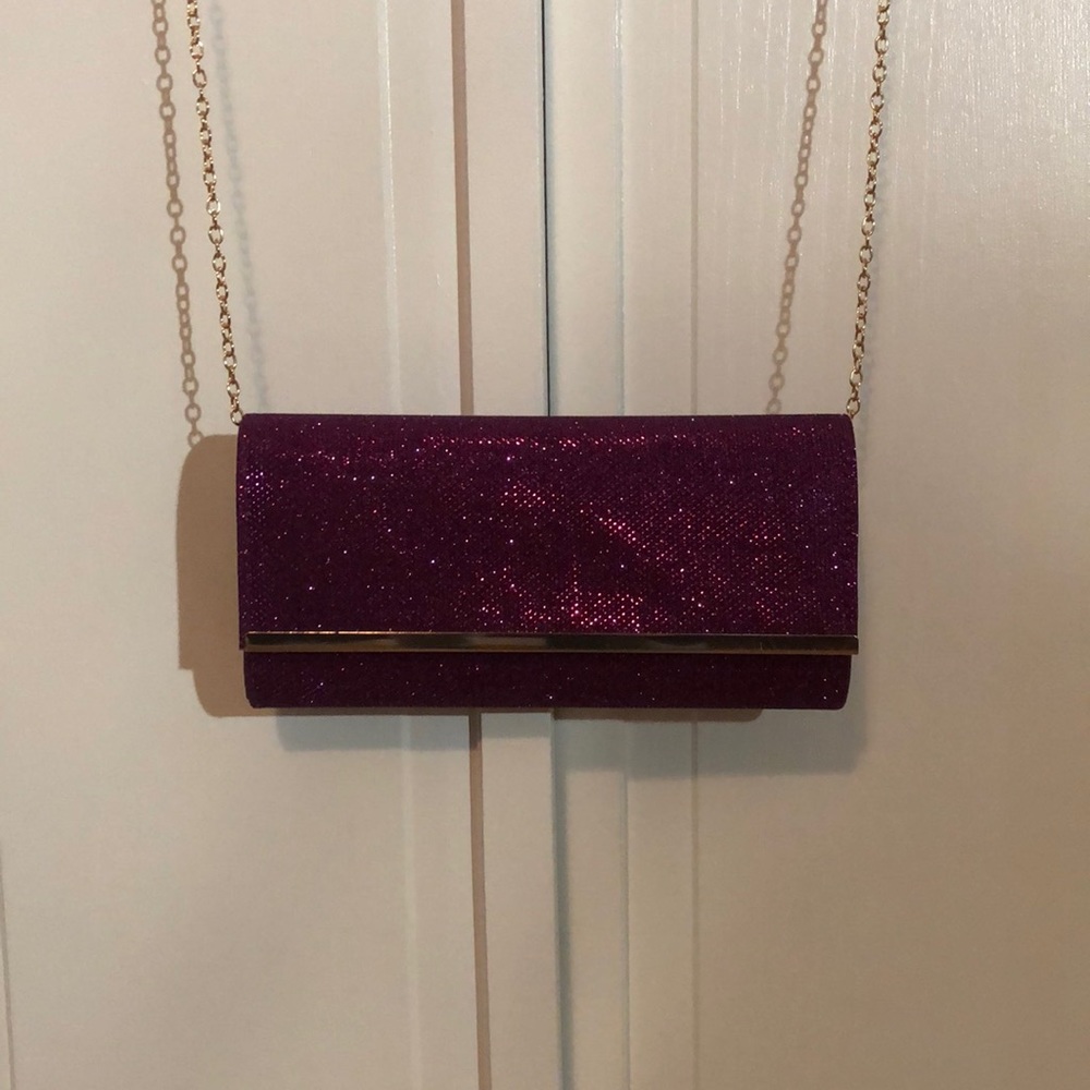 Purple evening clutch with tags